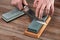 Man sharpening a Japanese chef`s knife with a wet whetstone