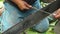 Man sharpens chainsaw blade with iron pile