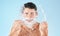 Man, shave and face with water splash in studio for wellness, health and self care by blue background. Model, bathroom