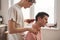 Man shaves neck of his boyfriend with an electric razor at home