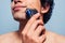 Man shaving with electric razor