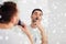 Man shaving mustache with trimmer at bathroom
