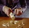 Man shaving square peg to fit round hole