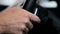 Man shifts gears using the paddles on the steering wheel