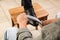 Man shining client`s shoe on wooden stool indoors