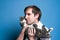 Man in shirt holding and snuggling up cheek to cute gray and white cat muzzle and looking away