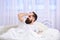 Man in shirt laying on bed awake, white curtain on background. Hangover concept. Macho with beard and mustache overslept