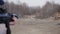 A man shoots at a target with an assault rifle at the shooting range.