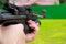 Man shoots at target from pneumatic gun at summer day