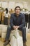 Man With Shopping Bags Sitting In Store