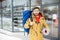 Man with shopping leaving a sports shop