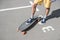 Man in shorts standing on longboard on street