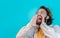 Man shouting loud calling attention with hands like megaphone isolated on blue studio background