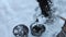 A man with a shovel rakes coal, covered with fresh snow, into buckets for heating a residential building