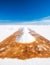 Man shovel sault banks in Salar de Uyuni