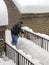 Man Shoveling Snow On Walkway