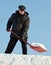 Man shovelling snow with a red shovel