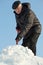 Man shovelling snow from a road