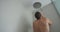 Man in shower washing hair showering in bathroom at home