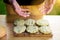 Man showing dirty hands after preparing meat and zucchini burgers, summer garden food concept