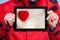 Man showing heart love symbol on tablet touchpad