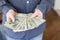 A man showing hundreds of Zloty - Polish money.