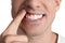 Man showing inflamed gums on white background, closeup