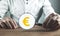 Man showing magnifying glass with a Euro symbol. Search money