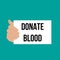 Man showing paper DONATE BLOOD text