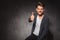 Man showing positive hand gesture while sitting in studio