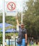 Man showing strange street sign om the road in India