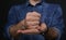 Man showing word CRUCIFY in sign language on black background