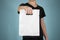 Man shows blank plastic bag mock up isolated. Empty white polyethylene package mockup. Consumer pack ready for logo design or ide