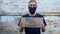 Man shows cardboard with Your Vote Counts sign on brick wall urban background. Voting concept. Political choice