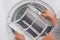 Man shows dust and dirt trapped by the after use clothes dryer filter.