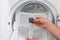 Man shows dust and dirt trapped by the after use clothes dryer filter.