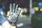 Man shows his hand, says stop virus by his hand in a black nitrile medical glove