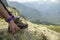 A man shows his hand to unstick from the sole of hiking boots