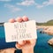 Man shows a signboard with the text never stop dreaming