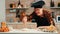 Man sieving flour over dough on table