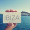 Man with a signboard with the word Ibiza, in Ibiza Town, Spain;