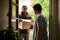 Man signing for a courier package at his front door