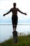 Man Silhouette Doing Yoga on a Stump in Nature