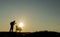 Man silhouette giving bread to stray dogs