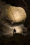 Man silhouette in a huge dark cave