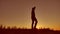 Man silhouette. Man walking on summer sunset meadow. man sunset travel video