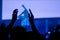 Man silhouette partying and clapping at rock concert