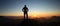 Man Silhouette reaching summit enjoying freedom and looking towards mountains sunset. Allgau Alps, Bavaria, Germany and