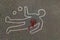 Man silhouette shape outline of dead body marked on road by chalk with evidence circled with blood strain on highway.