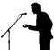 Man silhouette speech to microphone